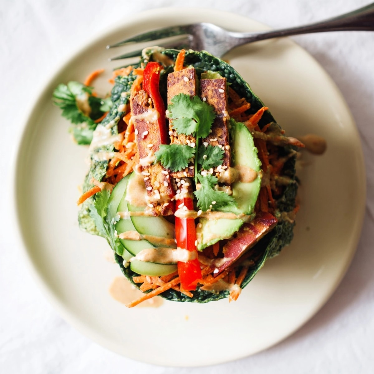 Nahaufnahme von frischen Kale Wraps Stuffed with Marinated Tempeh, perfekt gewickelt und servierfertig.