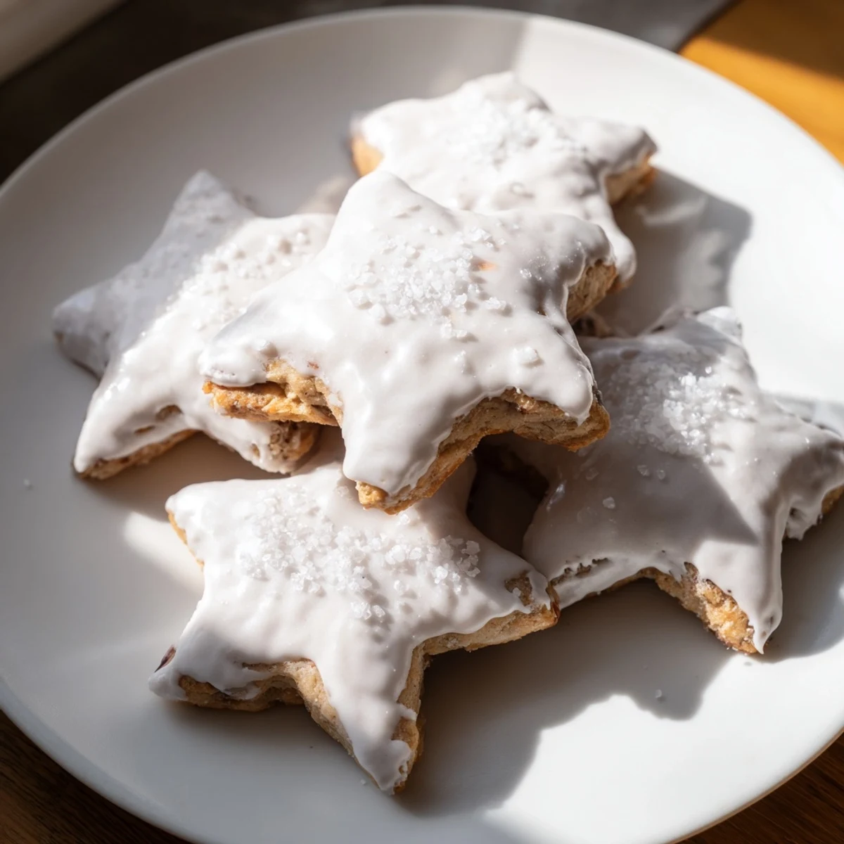 Close-up of frosted Cinnamon Stars cookies, a delightful German treat perfect for Christmas baking.