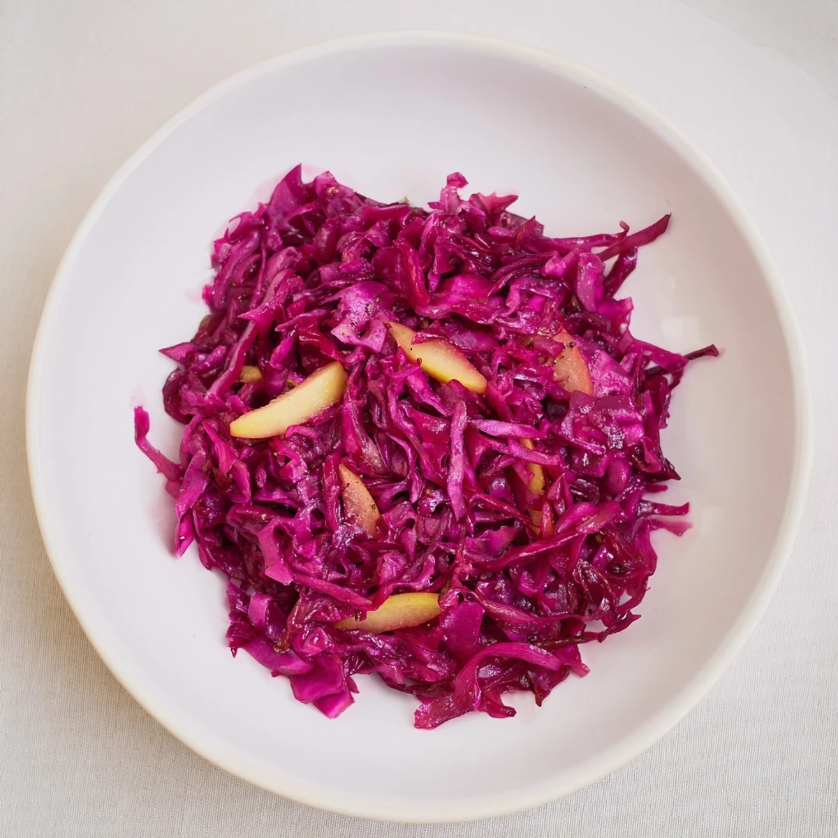 Steaming, vibrant Bavarian red cabbage with apples, ready to serve as a perfect side dish for any meal.