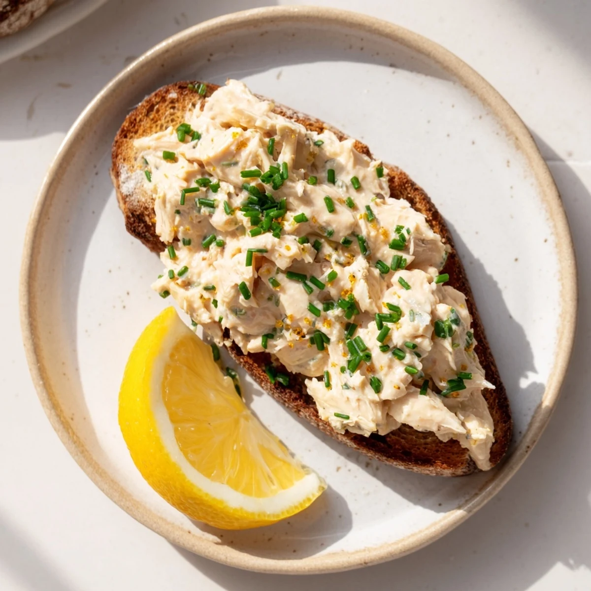 Golden Carp Pâté Tartine, a flavorful open-faced sandwich, perfect for a light lunch with lemon.