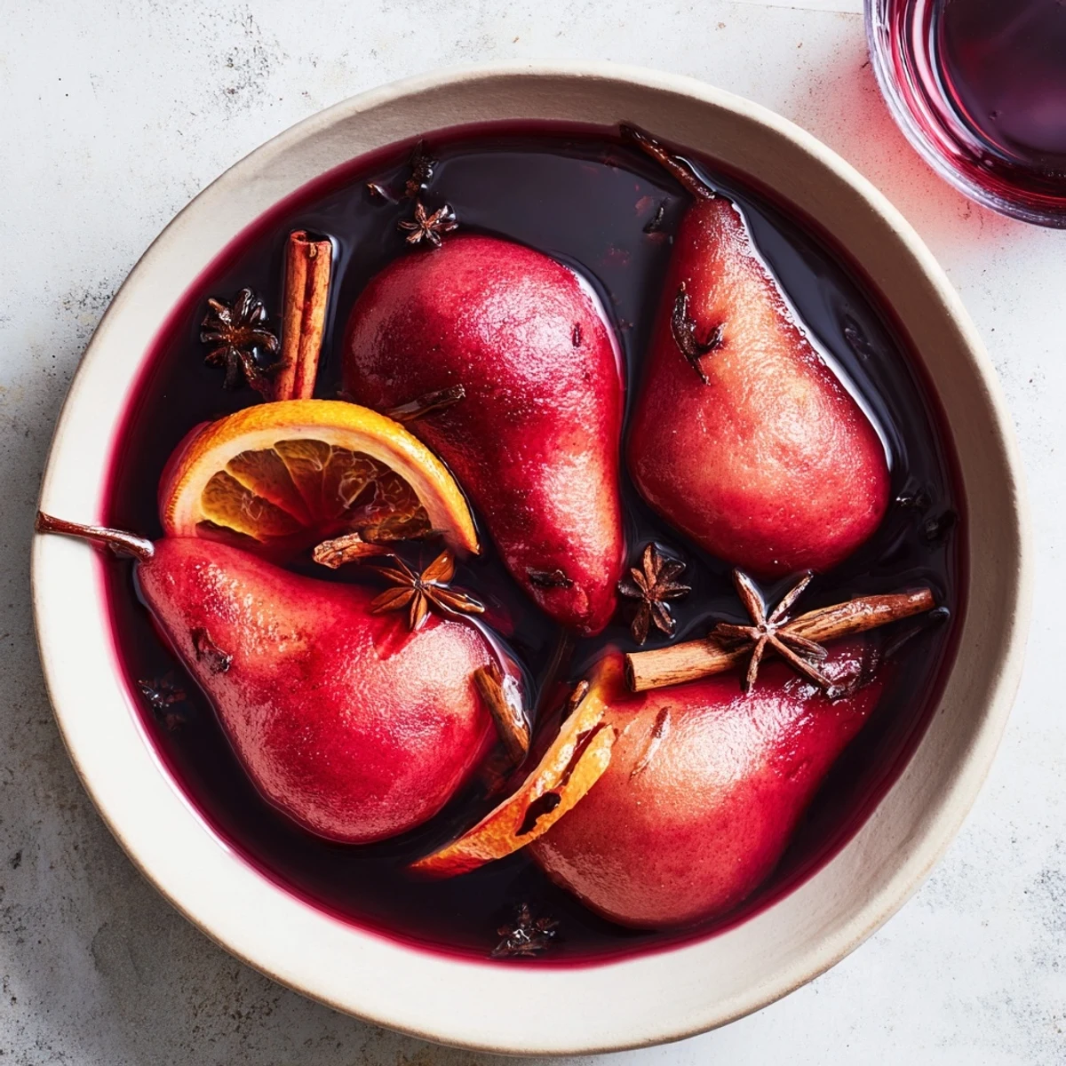 The finished Quick Glühwein poached pears, ready to serve with a drizzle of spiced red wine syrup.