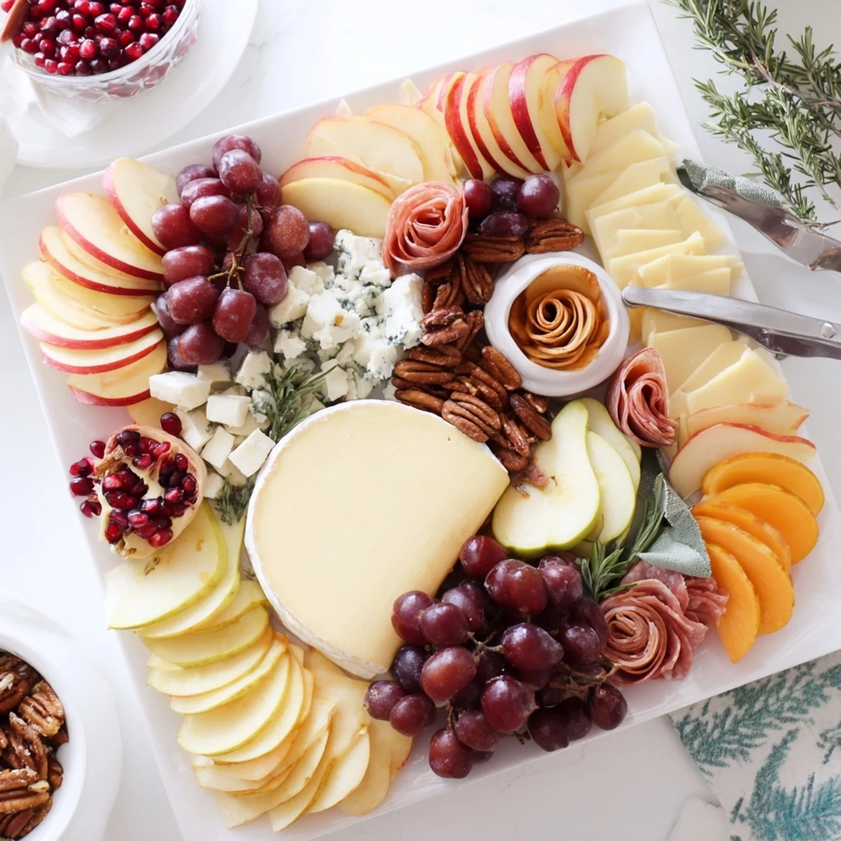 A beautiful Jingle Bell Cheese Board, overflowing with colorful fruits, cheeses, and holiday treats.