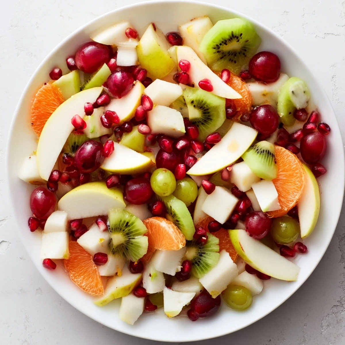 A vibrant Snowflake Fruit Medley, a sweet mix of colorful fruit glistening with citrus dressing.