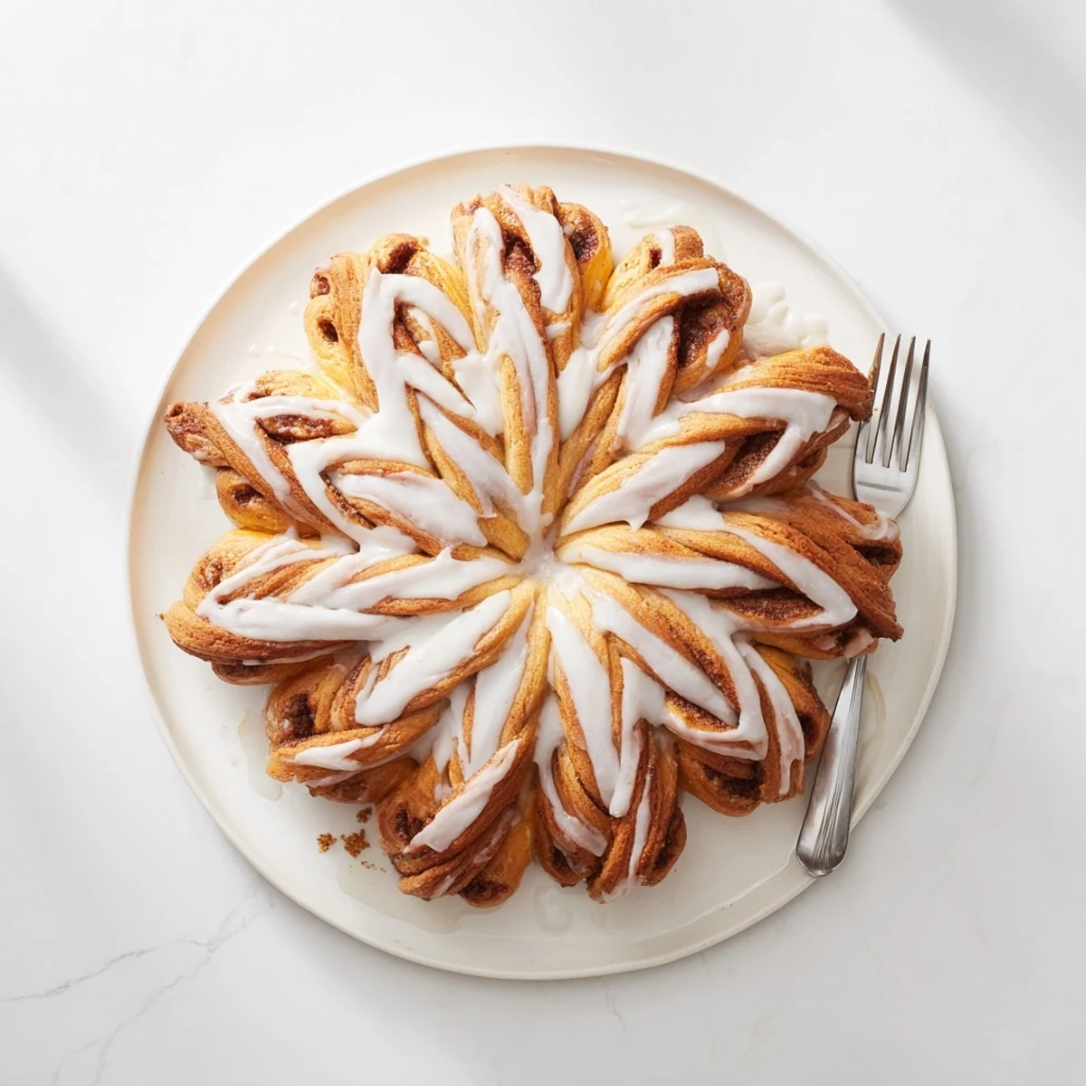 Freshly baked giant snowflake sweet roll centerpiece, ideal for sharing during festive family gatherings this season.