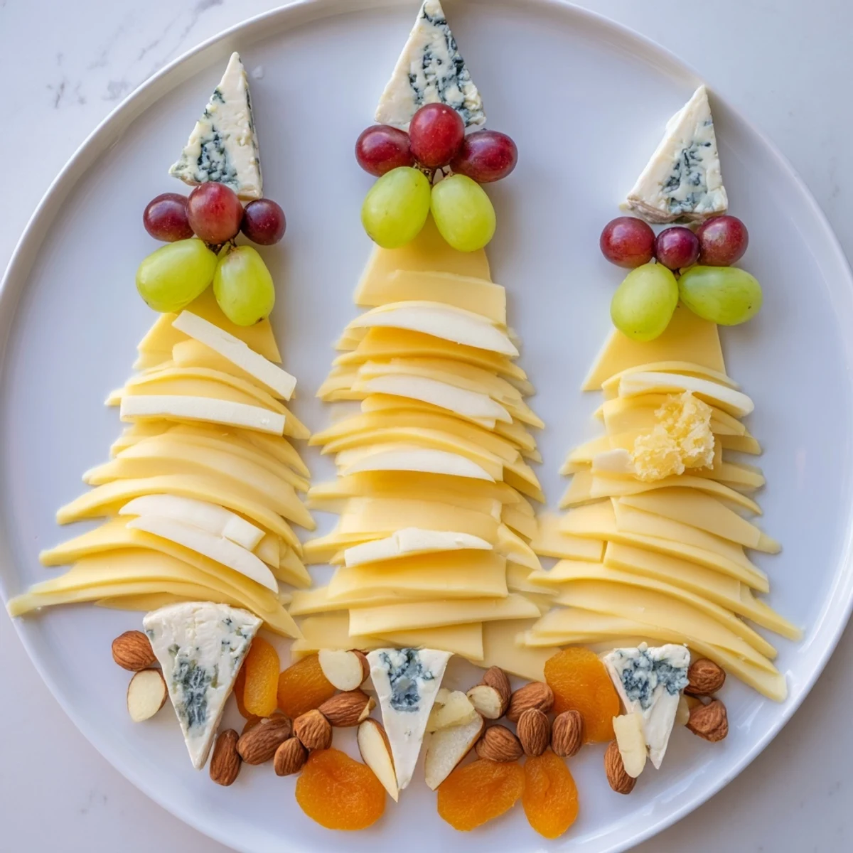 Elegant Art Deco Arch Cheese Platter, with brie, Gruyere, and vibrant fruit for serving.