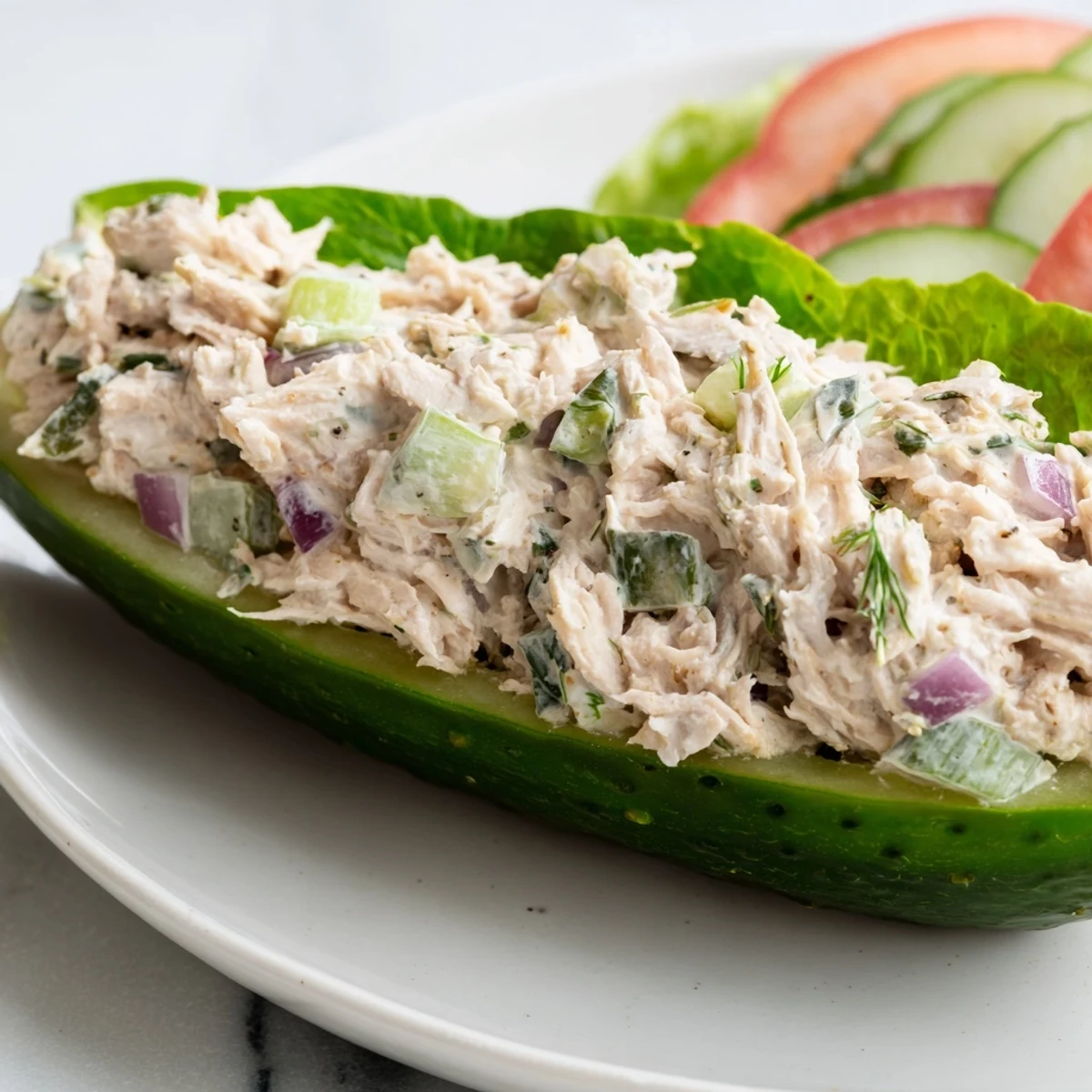 Juicy chicken salad overflowing a pickle sandwich, a low-carb delightful American meal.