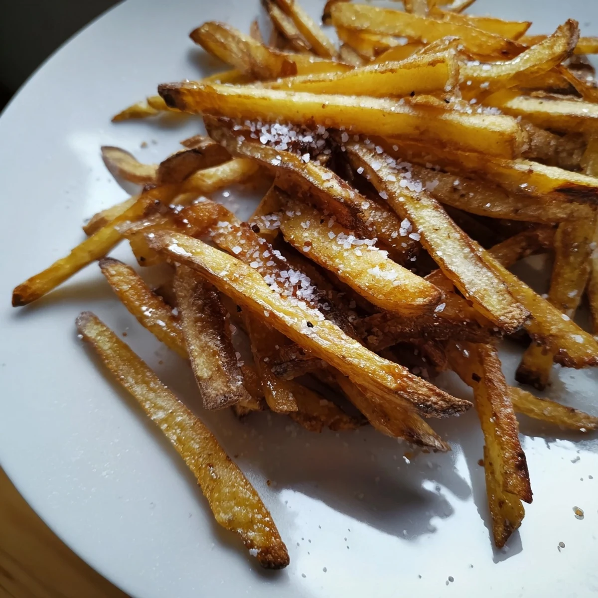 Golden, crispy homemade air-fryer potato chips, seasoned and ready for a delicious snack.