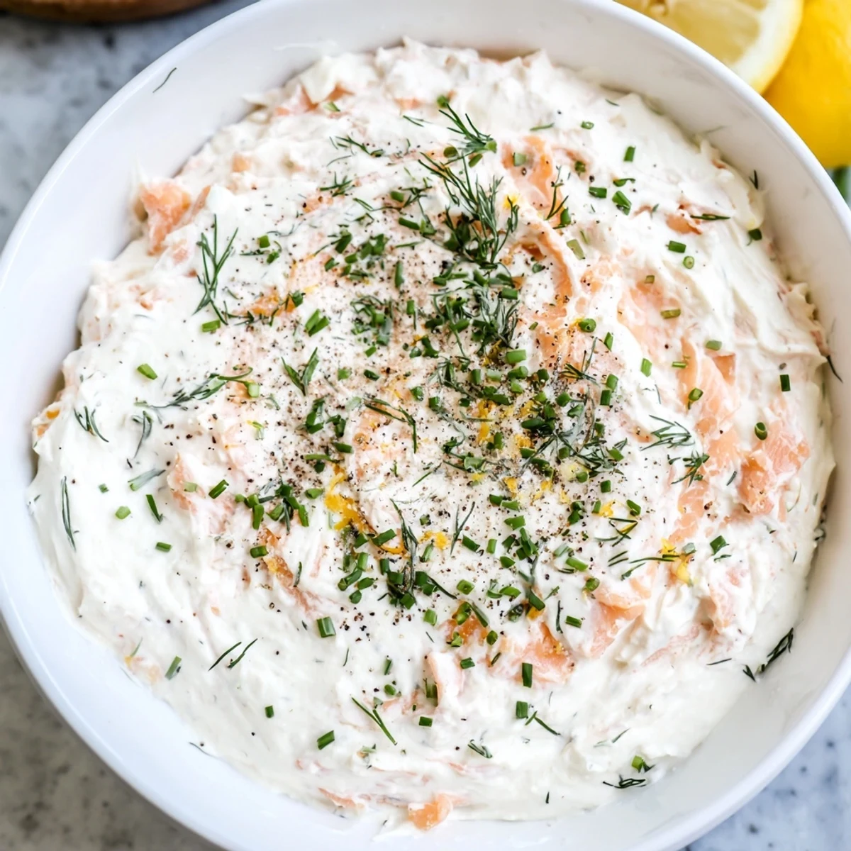 Close-up of a flavorful smoked salmon dip with chives, a quick and easy appetizer.