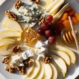 This Honeycomb, Honey & Cheese Board features a delightful mix of cheese, honey, and fresh fruit.