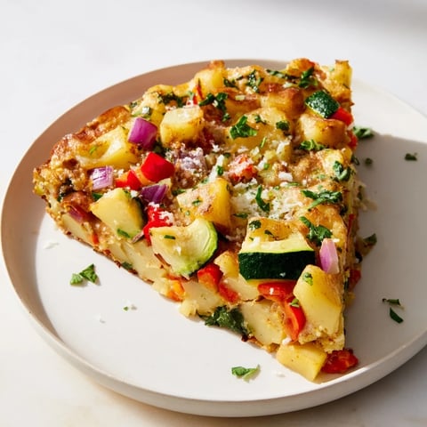 Golden-brown Potato and Vegetable Frittata, sizzling in a skillet, ready for brunch.