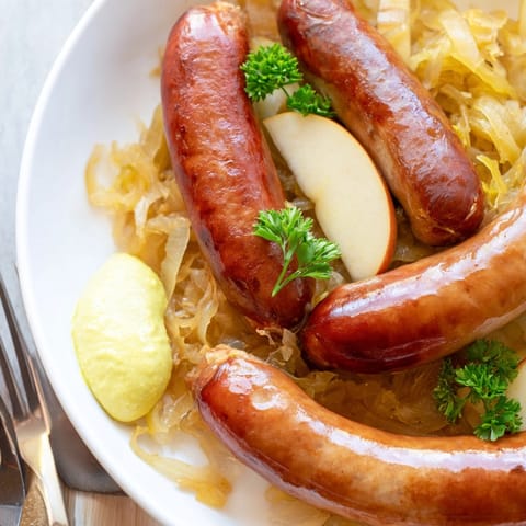 Hearty Oktoberfest Knackwurst and Sauerkraut: a delicious German meal, ready to serve.
