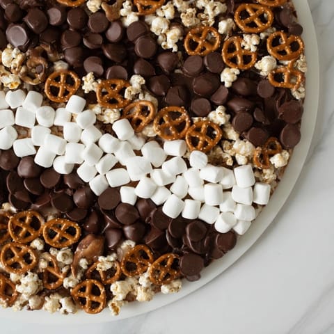 The vibrant Candy Corn Spooky Board, featuring orange, yellow, and white treats, perfect for Halloween snacking.