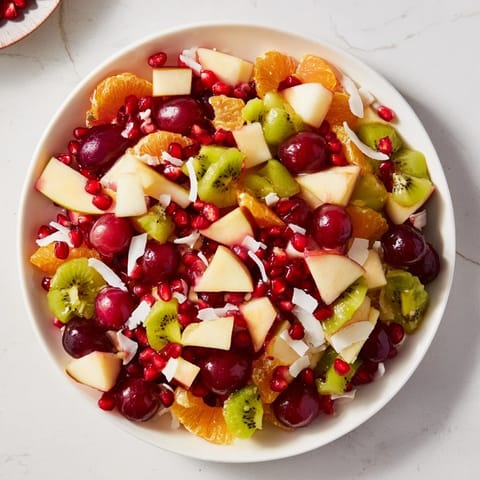Fresh Snowflake Fruit Medley topped with shredded coconut, a beautiful festive dessert salad.