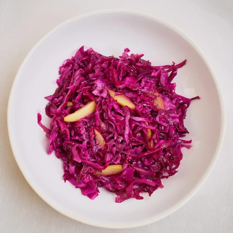 Steaming, vibrant Bavarian red cabbage with apples, ready to serve as a perfect side dish for any meal.