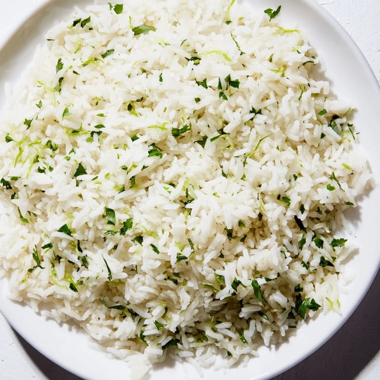 A close-up of cilantro lime rice, showing the fluffy texture and vibrant lime zest.
