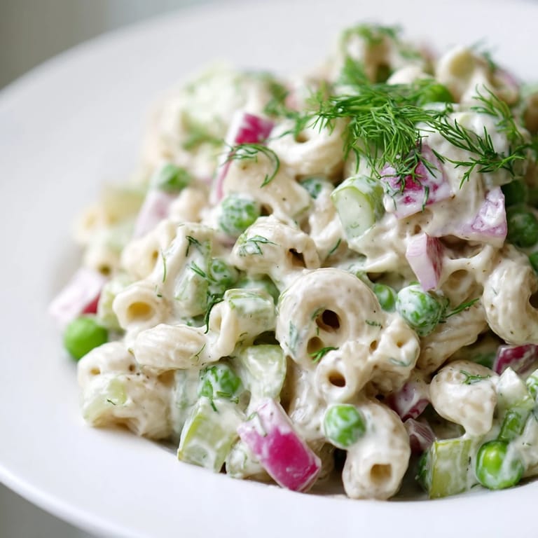 Colorful Creamy Dill Pickle Pasta Salad with ditalini pasta, peas, and a creamy, tangy dressing.