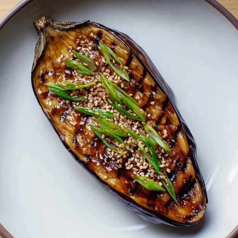 Roasted Miso Glazed Eggplant brushed with miso glaze and garnished with sesame seeds.