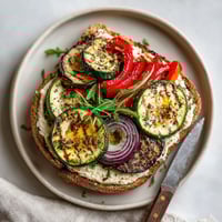 A sandwich with vegetables and hummus.